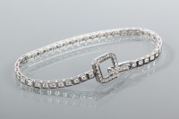 Lot 1834 - DIAMOND LINE BRACELET set with a row of...