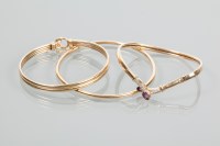 Lot 1845 - GROUP OF THREE NINE CARAT GOLD BANGLES one set...