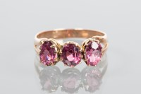 Lot 1881 - VICTORIAN GARNET THREE STONE RING set with...