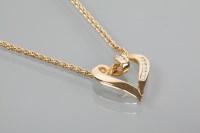 Lot 1882 - DIAMOND SET HEART PENDANT channel set with...