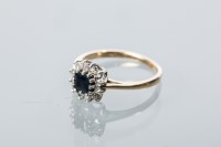 Lot 1908 - SAPPHIRE AND DIAMOND CLUSTER RING with a...