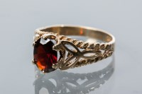 Lot 1909 - GARNET DRESS RING set with a central oval cut...