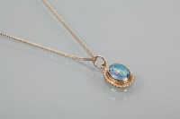 Lot 1927 - OPAL TRIPLET PENDANT with an oval cabochon...