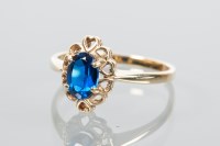 Lot 1930 - BLUE GEM SET RING with a central oval cut blue...