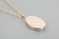 Lot 1966 - NINE CARAT GOLD LOCKET decorated with a criss...