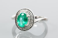 Lot 1970 - EMERALD AND DIAMOND CLUSTER RING the central...