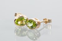 Lot 1972 - PAIR OF PERIDOT STUD EARRINGS each set with an...