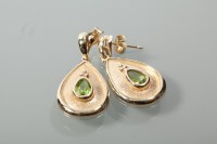 Lot 2039 - PAIR OF PERIDOT DROP EARRINGS each set with a...