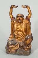 Lot 465 - CHINESE STONE PAINTED BUDDHA modelled with arm...