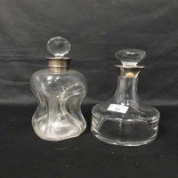 Lot 333 - TWO SILVER COLLARED DECANTERS along with a...