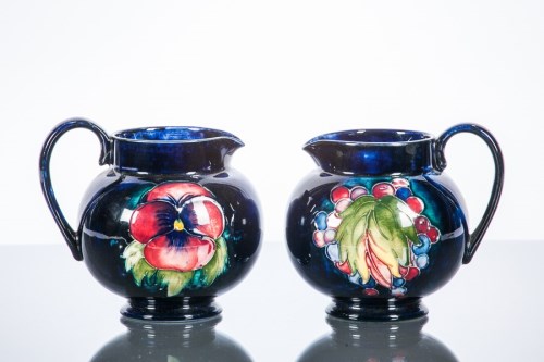 Lot 488 - TWO MOORCROFT JUGS one with 'leaf and berry'...