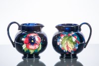Lot 488 - TWO MOORCROFT JUGS one with 'leaf and berry'...