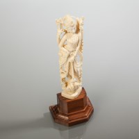 Lot 303 - INDIAN IVORY DEITY on rosewood base, 17cm high