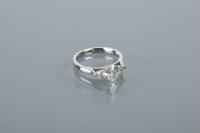 Lot 1640 - DIAMOND THREE STONE RING the central oval cut...