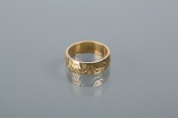 Lot 1692 - EIGHTEEN CARAT GOLD WEDDING BAND with engraved...