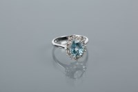 Lot 1716 - AQUAMARINE AND DIAMOND CLUSTER RING set with a...