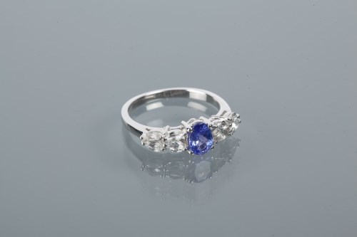 Lot 1755 - TANZANITE AND TOPAZ DRESS RING the central...