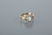 Lot 1772 - OPAL AND DIAMOND CLUSTER RING with a central...