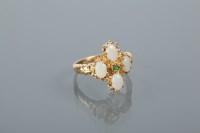 Lot 1780 - SYNTHETIC OPAL AND EMERALD RING set with four...