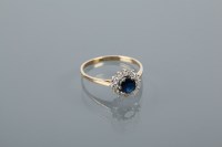 Lot 1794 - SAPPHIRE AND DIAMOND CLUSTER RING with a...