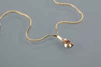 Lot 1795 - DIAMOND AND RUBY NECKLACE formed as a drop set...