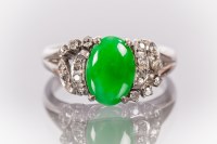 Lot 1628 - JADEITE AND DIAMOND DRESS RING with a central...
