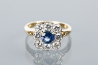 Lot 1634 - SAPPHIRE AND DIAMOND CLUSTER RING with a...