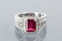Lot 1642A - RUBY AND DIAMOND DRESS RING the central...