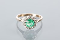 Lot 1652A - EMERALD AND DIAMOND CLUSTER RING the central...