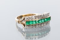 Lot 1660 - EMERALD AND DIAMOND RING with a row of square...