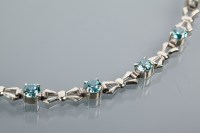 Lot 1668 - ZIRCON SET BRACELET set with eight round blue...