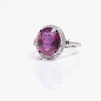 Lot 1641 - RUBY AND DIAMOND CLUSTER RING the central oval...