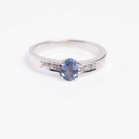 Lot 1672 - SAPPHIRE AND DIAMOND RING the central oval...