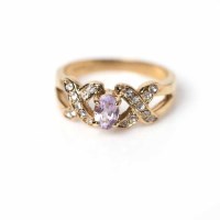 Lot 1702 - LILAC AND WHITE CZ RING with a central oval...