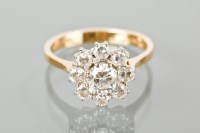 Lot 1139 - DIAMOND CLUSTER RING set with a central...