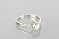 Lot 1143 - ZIRCON SOLITAIRE RING the round zircon in...