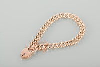 Lot 1152 - NINE CARAT GOLD CURB LINK BRACELET with a...