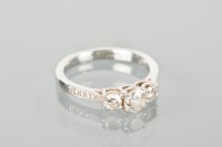 Lot 1166 - DIAMOND THREE STONE RING the central diamond...