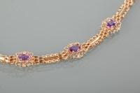 Lot 1180A - AMETHYST SET BRACELET set with three oval cut...