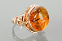 Lot 1196 - AMBER DRESS RING set with a section of amber...