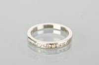 Lot 1205 - DIAMOND HALF ETERNITY RING channel set with...