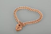 Lot 1211 - NINE CARAT GOLD CURB LINK BRACELET with a...