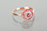 Lot 1215 - RUBY AND DIAMOND CLUSTER RING with a central...