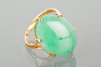Lot 1222 - JADE SET RING with an oval section of jade...