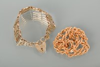 Lot 1253 - NINE CARAT GOLD BRACELET with a heart-shaped...