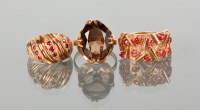 Lot 1272 - THREE 1970S DRESS RINGS comprising a smoky...