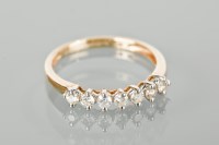 Lot 1280 - DIAMOND HALF ETERNITY RING set with a row of...