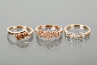 Lot 1293 - GROUP OF THREE COGNAC DIAMOND RINGS comprising...