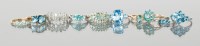 Lot 1295 - GROUP OF NINE CARAT GOLD BLUE GEM SET RINGS...