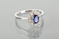Lot 1339 - SAPPHIRE AND DIAMOND CLUSTER RING with a...